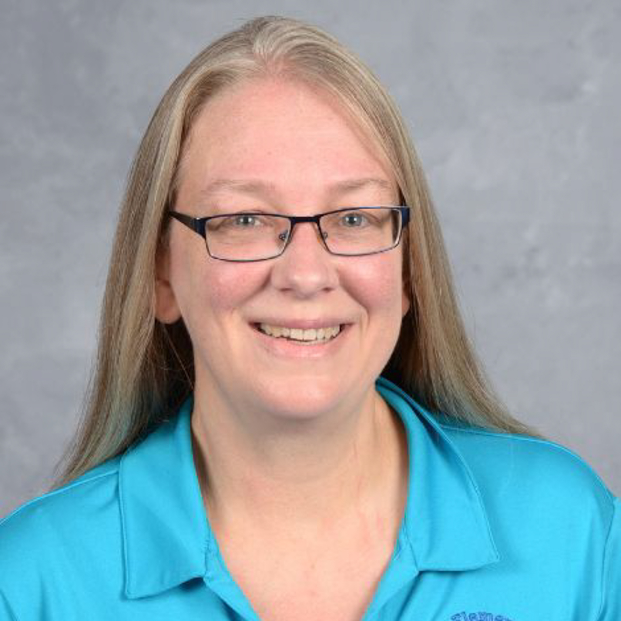 Photo of Beth Kirby, woman in turquoise shirt