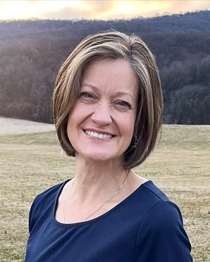 Photo of Beth Kirby, woman in turquoise shirt